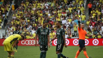 NASHVILLE, TN - SEPTEMBER 10: Los Angeles Galaxy midfielder Víctor Vázquez (7) is shown a yellow card from the game official after pulling down Nashville SC midfielder Hany Mukhtar (10) during a match between Nashville SC and Los Angeles Galaxy, September 10, 2022 at GEODIS Park in Nashville, Tennessee. (Photo by Matthew Maxey/Icon Sportswire via Getty Images)