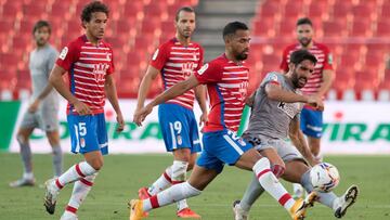 Granada's Venezuelan midfielder Yangel Herrera (L) vies with Athletic Bilbao's Spanish forward Raul Garcia during the Spanish league football match Granada FC against Athletic Club Bilbao at Los Carmenes stadium in Granada on September 12, 202