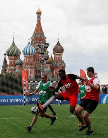 Players take part in a match between teams of refugees from Syria, Afghanistan, Cameroon, Zimbabwe and Ivory Coast at a makeshift pitch in Red Square in Moscow