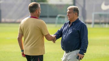 Barcelona's German coach Hansi Flick (L) shakes hands with FC Barcelona president Joan Laporta during his first training session as Barcelona's new head coach at the Joan Gamper training ground in Sant Joan Despi, near Barcelona, on July 19, 2024. Former German coach of Bayern Munich Hansi Flick was appointed on May 29, 2024, as new Barcelona's coach on a deal which runs till June 2026, after sacking Xavi Hernandez. (Photo by Manaure QUINTERO / AFP)