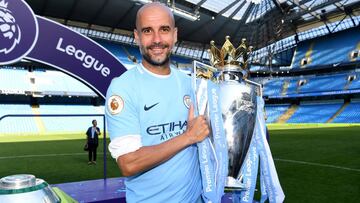 Josep Guardiola, Manager of Manchester City poses with The Premier League Trophy after the Premier League match between Manchester City and Huddersfield Town at Etihad Stadium on May 6, 2018 in Manchester, England.