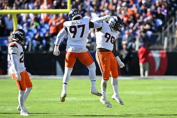 Malcolm Roach #97 and John Franklin-Myers #98 of the Denver Broncos celebrate 