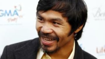 ESTRELLA. El boxeador Manny Pacquiao, posa ante la prensa en el estreno del film 'The Road'