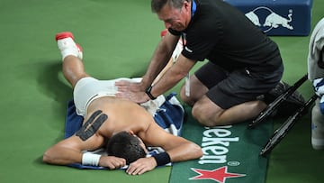 Serbia's Novak Djokovic receives physio during his men's singles semi-final match against Monaco's Valentin Vacherot at the Shanghai Masters tennis tournament in Shanghai on October 11, 2025. (Photo by Jade Gao / AFP)