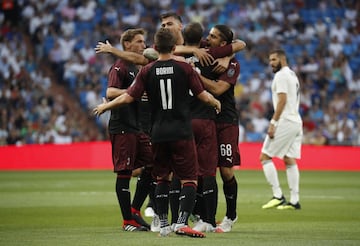 The AC Milan players celebrate Higuaín's leveller.