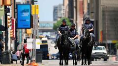 DALLAS, TEXAS - MAY 01: Dallas Police Department officers patrol through downtown Dallas in horseback on May 01, 2020 in Dallas, Texas. Texas Governor Greg Abbott relaxed restrictions on businesses allowing retail stores, restaurants, movie theaters and m