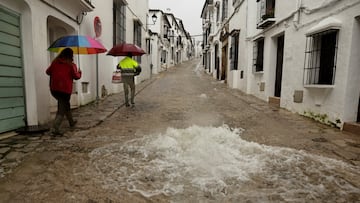 People walk along a flooded street due to heavy rains, as storm Leonardo hits parts of Spain, in Grazalema, Spain, February 5, 2026. REUTERS/Jon Nazca TPX IMAGES OF THE DAY