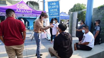 Temperatures are taken from people waiting to receive their Covid-19 vaccines from AltaMed Health Services in Los Angeles, California on August 17, 2021.