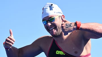 France's Logan Fontaine celebrates after winning the final of the men's 5km open water swimming event during the 2024 World Aquatics Championships at Doha Port in Doha on February 7, 2024. (Photo by Manan VATSYAYANA / AFP)