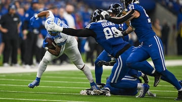Nov 24, 2024; Indianapolis, Indiana, USA; Detroit Lions running back David Montgomery (5) jukes to avoid several Indianapolis Colts during the second half at Lucas Oil Stadium. Mandatory Credit: Marc Lebryk-Imagn Images