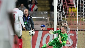 Barcelona's German goalkeeper #01 Marc-Andre Ter Stegen (R) fails to save a shot kicked by Monaco's French forward #21 George Ilenikhena during the UEFA Champions League 1st round day 1 football match between AS Monaco and FC Barcelona at the Louis II Stadium in the Principality of Monaco on September 19, 2024. (Photo by Miguel MEDINA / AFP)