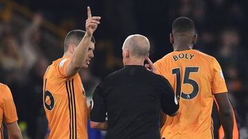 Wolverhampton Wanderers&#039; English defender Conor Coady (L) questions English referee Mike Dean about the decision disallowing a goal from Wolverhampton Wanderers&#039; French defender Willy Boly for offside after a VAR (Video Assistant Referee) review