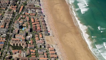A large number of 19th-century boots have washed up on a beach in South Wales. Their origin remains a mystery.