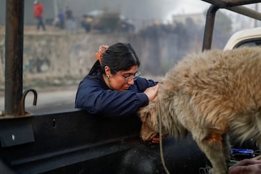 Una persona acaricia a un perro después de un incendio forestal en la región del Biobío, donde, según medios locales, múltiples incendios forestales provocaron evacuaciones de emergencia, en Concepción, Chile.