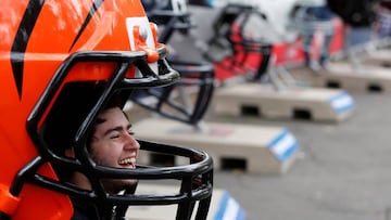 A man smiles as he poses for a photograph with the Cincinnati Bengals helmet during the NFL Fan Fest before the Oakland Raiders v Houston Texans football game on Monday in Mexico City, Mexico November 19, 2016. REUTERS/Carlos Jasso