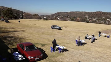 Teachers wait for parents to drive-through as they fetch school work and Term 1 reports for their children, amid the spread of the coronavirus disease (COVID-19) at Mondeor High School, south of Johannesburg, South Africa June 13, 2020. REUTERS/Siphiwe Si