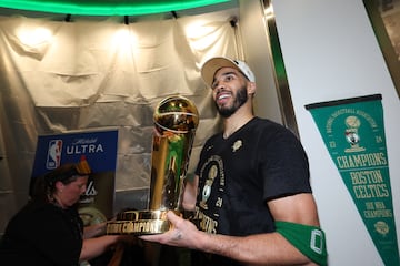 Boston Celtics forward Jayson Tatum (0) holds the Larry O’Brien Championship Trophy