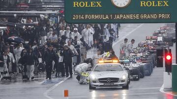 Cars line up behind the safety car in the pit lane as the race is suspended due to rain conditions during the Japanese F1 Grand Prix at the Suzuka Circuit October 5, 2014. REUTERS/Toru Hanai (JAPAN - Tags: SPORT MOTORSPORT F1 ENVIRONMENT)