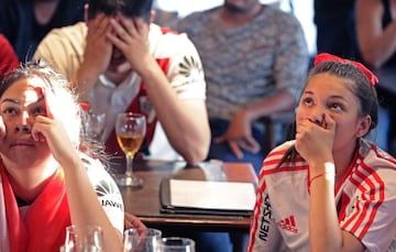 Fans of Argentina's River Plate team react after their team lost 2-1 the Copa Libertadores football final against Brazil's Flamengo at a bar in Buenos Aires, on November 23, 2019. 