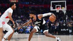 Jan 10, 2024; Los Angeles, California, USA; Los Angeles Clippers forward Paul George (13) controls the ball against Toronto Raptors center Jontay Porter (11) during the second half at Crypto.com Arena. Mandatory Credit: Gary A. Vasquez-USA TODAY Sports