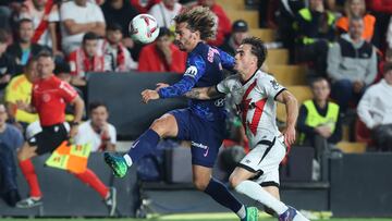 Atletico Madrid's French forward #07 Antoine Griezmann (L) fights for the ball with Rayo Vallecano's Spanish defender #03 Pep Chavarria during the Spanish league football match between Rayo Vallecano de Madrid and Club Atletico de Madrid at the Vallecas stadium in Madrid on September 22, 2024. (Photo by Thomas COEX / AFP)
