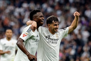 Real Madrid's Brazilian forward #07 Vinicius Junior (L) celebrates scoring his team's fourth goal, with Real Madrid's Moroccan forward #21 Brahim Diaz, during the Spanish league football match between Real Madrid CF and CA Osasuna at the Santiago Bernabeu stadium in Madrid on November 9, 2024. (Photo by OSCAR DEL POZO / AFP)