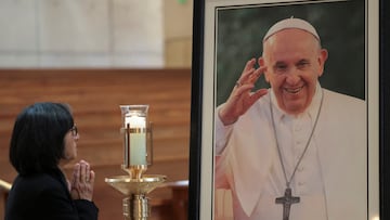 A person stands near a portrait of Pope Francis, displayed at the Cathedral of Our Lady of the Angels, following the death of the pontiff, in Los Angeles, California, U.S., April 21, 2025. REUTERS/Mario Anzuoni