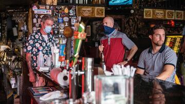 People sit at the bar of a restaurant in Austin, Texas, June 26, 2020. - Texas Governor Greg Abbott ordered bars to be closed by noon on June 26 and for restaurants to be reduced to 50% occupancy. Coronavirus cases in Texas have spiked in recent weeks aft