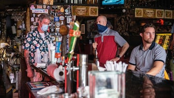 People sit at the bar of a restaurant in Austin, Texas, June 26, 2020. - Texas Governor Greg Abbott ordered bars to be closed by noon on June 26 and for restaurants to be reduced to 50% occupancy. Coronavirus cases in Texas have spiked in recent weeks aft