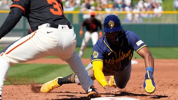 Mar 5, 2024; Scottsdale, Arizona, USA; Milwaukee Brewers Jackson Chourio (11) dives back into first base against the San Francisco Giants in the third inning at Scottsdale Stadium. Mandatory Credit: Rick Scuteri-USA TODAY Sports