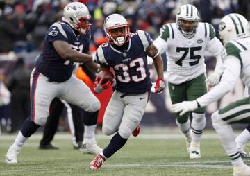 New England Patriots running back Dion Lewis (33) runs through the New York Jets defense during the second half of New England's 26-6 win at Gillette Stadium.