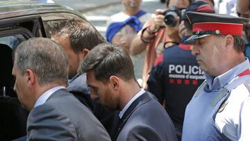 FILE - In this Thursday, June 2, 2016 file photo, Barcelona soccer player Lionel Messi, center, leaves a court in Barcelona, Spain. A Barcelona court Wednesday, July 6, 2016 has given Lionel Messi and his father suspended sentences of 21 months in prison for tax fraud. In Spain, sentences of less than two years for first offences are suspended, meaning neither man will go to jail. (AP Photo/Manu Fernandez, File)