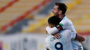 Argentina's Joaquin Correa celebrates with teammate Lionel Messi (top) after scoring against Bolivia during their 2022 FIFA World Cup South American qualifier football match at the Hernando Siles Stadium in La Paz on October 13, 2020, amid the COVID-