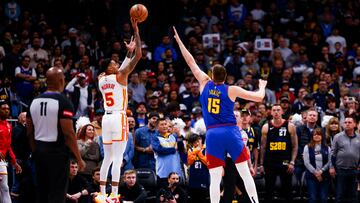 Apr 6, 2024; Denver, Colorado, USA; Atlanta Hawks guard Dejounte Murray (5) takes a shot over Denver Nuggets center Nikola Jokic (15) in the first half at Ball Arena. Mandatory Credit: Michael Ciaglo-USA TODAY Sports