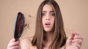 Sad girl looking at damaged hair, the hair loss problem. Isolated, copy space