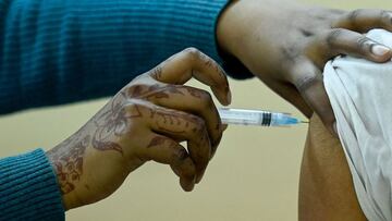 A medical worker inoculates a sanitation Worker of Municipal Corporation of Delhi (MCD) with a Covid-19 coronavirus vaccine at a vaccination centre in New Delhi on February 20, 2021. (Photo by Prakash SINGH / AFP)