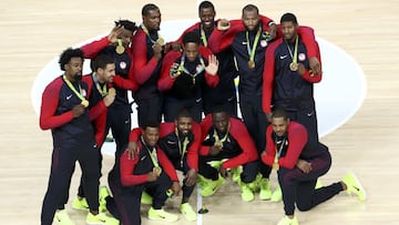 United States players pose with their gold medals during the presentation ceremony for men's basketball.
