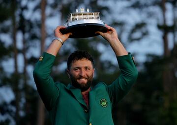 Spain's Jon Rahm celebrates with his green jacket and the trophy after winning The Masters 