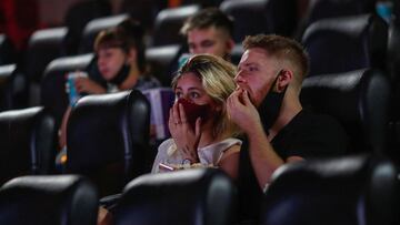 People wearing protective face masks are seen inside a movie theater, as cinemas in Argentina reopen amid an easing of new coronavirus disease (COVID-19) infections, in Buenos Aires, Argentina March 3, 2021. Picture taken March 3, 2021. REUTERS/Agustin Marcarian