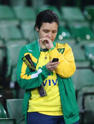 A Norwich fan looks dejected at the end of the match after being relegated from the Barclays Premier League