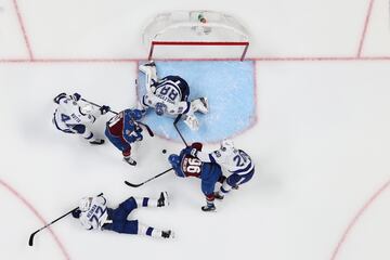 Nazem Kadri #91 and Mikko Rantanen #96 of the Colorado Avalanche try to score while defended by Jan Rutta #44