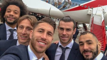 Luka Modrid and his team mates prepare to board a flight to Abu Dhabi ahead of the World Club Cup