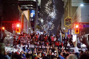 TORONTO, ON - JUNE 13: Toronto Raptors fans celebrate atop a bus after the team beat the Golden State Warriors in Game Six of the NBA Finals, on June 13, 2019 in Toronto, Canada. 
