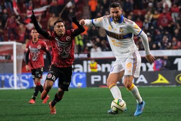 Tigres' Andre-Pierre Gignac (R) vies for the ball with Tijuana's Jose Vazquez (L) during  their Mexican Closura 2023 tournament football match at the Caliente stadium in Tijuana, Baja California state, Mexico, on January 20, 2023. (Photo by Guillermo Arias / AFP)