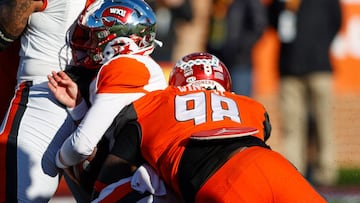 American squad quarterback Bailey Zappe of Western Kentucky (17) is sacked by National Squad defensive lineman Perrion Winfrey of Oklahoma (98).