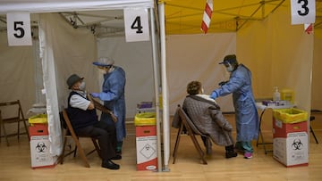 81 years old Pedro Perez Medrano closes to his wife Francisca Perez Solano receive a Pfizer vaccine during a COVID-19 vaccination campaign at the bull ring in Arnedo, northern Spain, Thursday, March 4, 2021. The La Rioja regional government has called all residents of the city, over the age of 80, to be vaccinated against COVID-19. (AP Photo/Alvaro Barrientos)