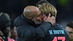 Manchester City's Spanish manager Pep Guardiola (L) embraces Manchester City's Belgian midfielder #17 Kevin De Bruyne (R) on the pitch after the English FA Cup fourth round football match between Tottenham Hotspur and Manchester City at Tottenham Hotspur Stadium in London, on January 26, 2024. City won the game 1-0. (Photo by Glyn KIRK / AFP) / RESTRICTED TO EDITORIAL USE. No use with unauthorized audio, video, data, fixture lists, club/league logos or 'live' services. Online in-match use limited to 120 images. An additional 40 images may be used in extra time. No video emulation. Social media in-match use limited to 120 images. An additional 40 images may be used in extra time. No use in betting publications, games or single club/league/player publications. / 