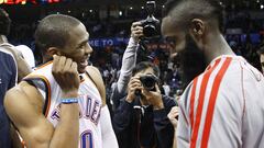 Oklahoma City Thunder guard Russell Westbrook (L) smiles as he and former teammate and Houston Rockets guard James Harden (R) share talk after an NBA basketball game in Oklahoma City, Oklahoma November 28, 2012. REUTERS/Bill Waugh (UNITED STATES - Tags: SPORT BASKETBALL)