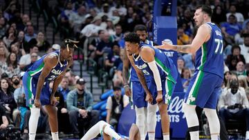 Luka Doncic #77 of the Dallas Mavericks gestures to the sideline as teammate Jaden Hardy #3 lays on the court during the second half against the Charlotte Hornets at American Airlines Center on March 24, 2023 in Dallas, Texas.