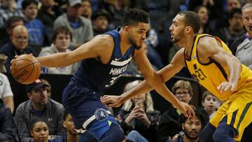 Apr 1, 2018; Minneapolis, MN, USA; Minnesota Timberwolves center Karl-Anthony Towns (32) controls the ball against Utah Jazz center Rudy Gobert (27) in the fourth quarter at Target Center. Mandatory Credit: Bruce Kluckhohn-USA TODAY Sports